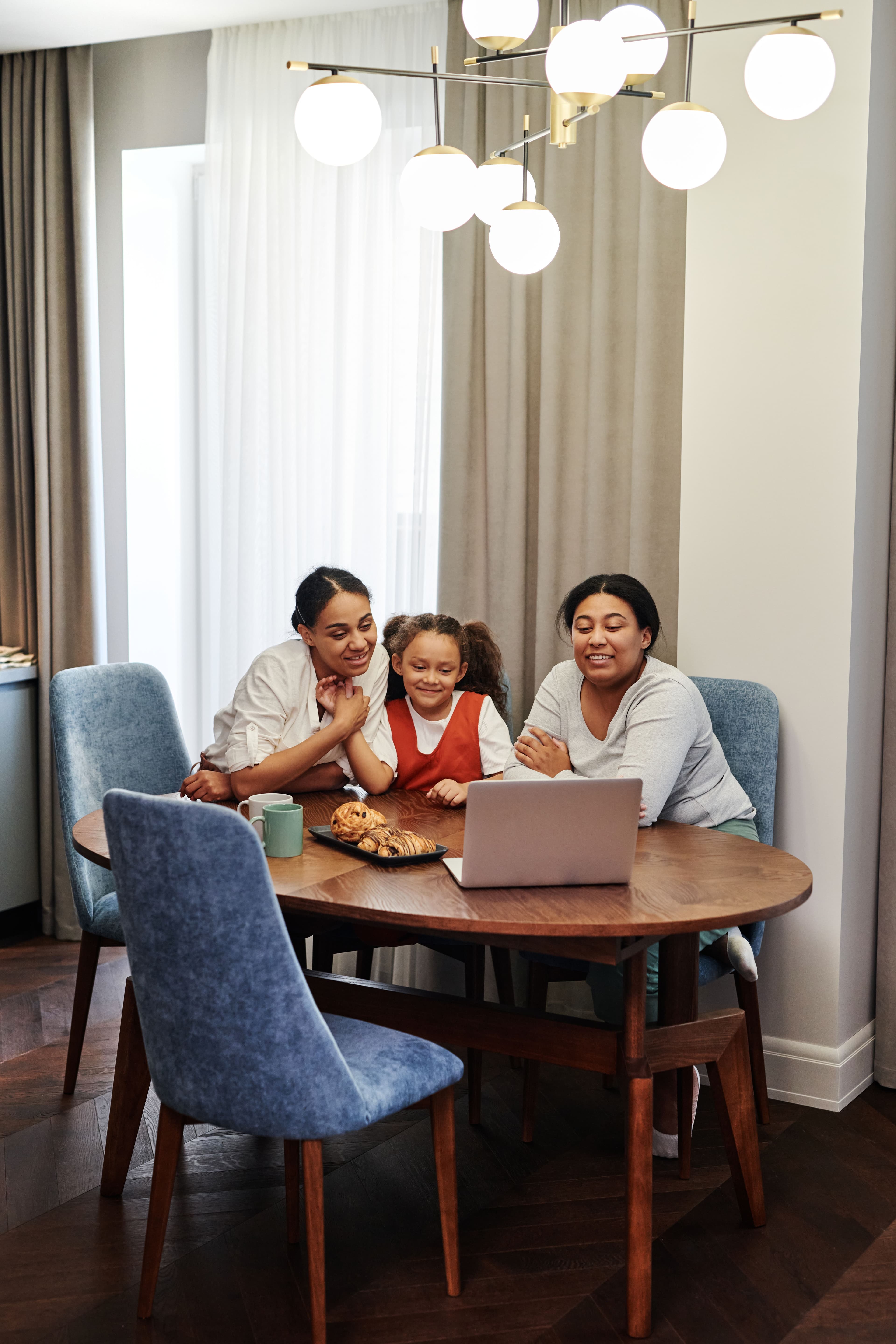 Family gathered around a laptop together